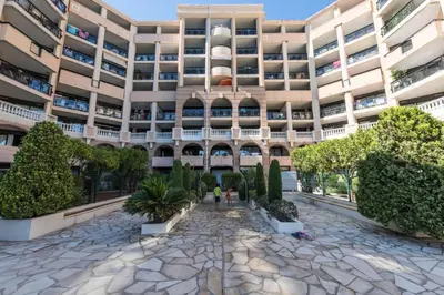 a large building with a courtyard with potted plants at Résidence Cannes Verrerie - maeva Home - Appartement 3 Pièces 6 Personnes - Sélection MAE-4213 in Cannes
