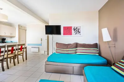 a living room with a bed and a kitchen at Résidence Cannes Verrerie - maeva Home - Appartement 3 Pièces 6 Personnes - Sélection MAE-4213 in Cannes