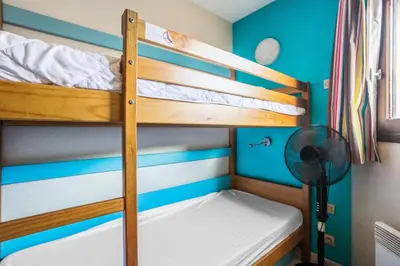 a bunk bed room with two bunk beds and a fan at Résidence Cannes Verrerie - maeva Home - Appartement 3 Pièces 6 Personnes - Sélection MAE-4213 in Cannes