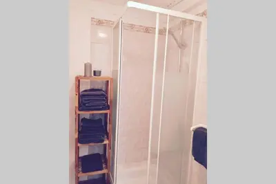 a bathroom with a shower and some blue towels at Cannes 78 rue meynadier plage, Mipim Festival 3 minutes à pieds in Cannes