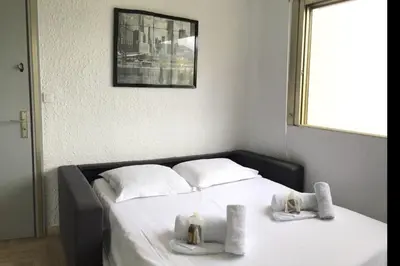 a bedroom with a bed with towels on it at Studio 