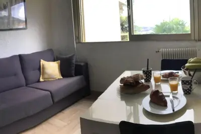 a living room with a couch and a table at Studio 