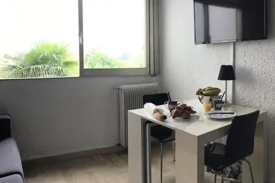 a white table and chairs in a room with a window at Studio 