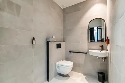 a bathroom with a toilet and a sink at RESIDENCE MONTEFIORE in Cannes