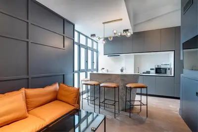 a living room with a couch and a kitchen at RESIDENCE MONTEFIORE in Cannes