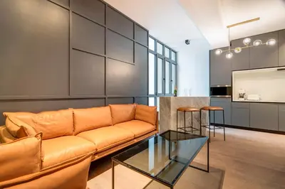 a living room with a couch and a glass table at RESIDENCE MONTEFIORE in Cannes