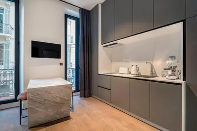 a kitchen with gray cabinets and a counter top at RESIDENCE MONTEFIORE in Cannes