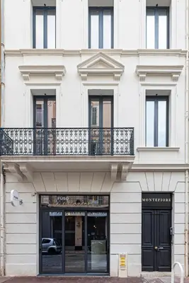 a facade of a white building with a balcony at RESIDENCE MONTEFIORE in Cannes