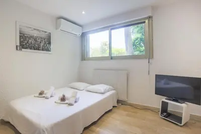 a bedroom with a bed and a flat screen tv at Studio AC 