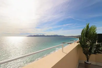 a view of the ocean from the balcony of a resort at Charming Apartment on Seafront with Rooftop in Cannes