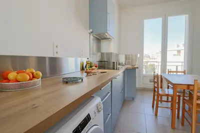 a kitchen with a counter with a bowl of fruit on it at Charming Apartment on Seafront with Rooftop in Cannes