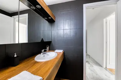 a bathroom with a sink and a mirror at 4P Modern & Secured Parking in Le Cannet