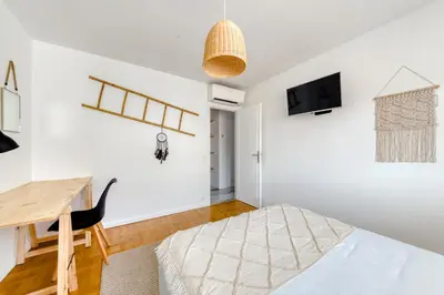 a room with a desk and a bed and a table at 4P Modern & Secured Parking in Le Cannet