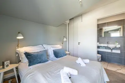 a bedroom with a large bed with towels on it at LE BOREAL penthouse avec terrasse et vue panoramique spectaculaire sur la ville in Cannes