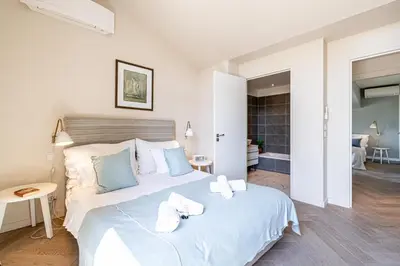 a bedroom with a large white bed with towels on it at LE BOREAL penthouse avec terrasse et vue panoramique spectaculaire sur la ville in Cannes