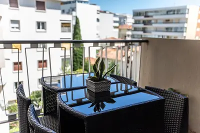 a table with a potted plant on a balcony at ++++ renovated cosy 50m2 sunny flat / balcony / close to beach and to the Palais des festivals ++++ in Cannes