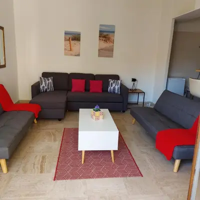 a living room with couches and a coffee table at ++++ renovated cosy 50m2 sunny flat / balcony / close to beach and to the Palais des festivals ++++ in Cannes
