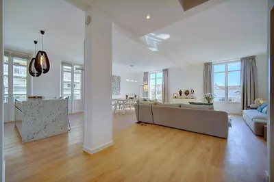 a large living room with a couch and a table at IMMOGROOM - Magnificent 180m duplex apartment - Parking - Air conditioning in Cannes