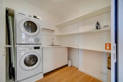 a laundry room with a washer and dryer at IMMOGROOM - Magnificent 180m duplex apartment - Parking - Air conditioning in Cannes