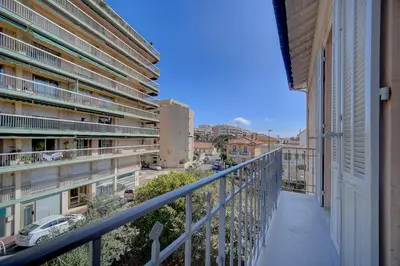 an apartment balcony with a view of a street at IMMOGROOM - Magnificent 180m duplex apartment - Parking - Air conditioning in Cannes
