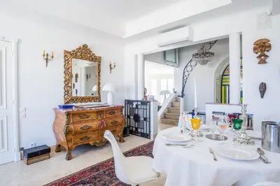 a dining room with a table and a mirror at Art Deco Luxury Apartment with Breath Taking View on Cannes Bay by Olidesi in Cannes