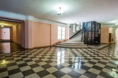 a hallway with a checkered floor and stairs at Art Deco Luxury Apartment with Breath Taking View on Cannes Bay by Olidesi in Cannes