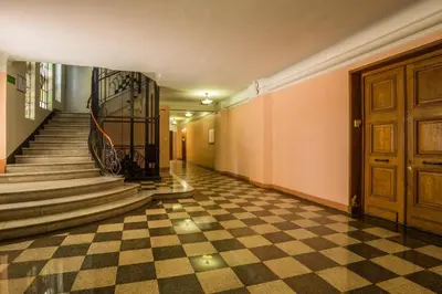 a hallway with a checkered floor and a staircase at Art Deco Luxury Apartment with Breath Taking View on Cannes Bay by Olidesi in Cannes