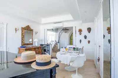 a dining room with a table with hats on it at Art Deco Luxury Apartment with Breath Taking View on Cannes Bay by Olidesi in Cannes