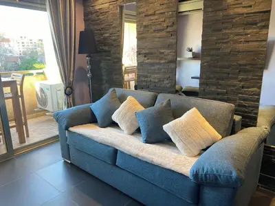 a blue couch with pillows in a living room at Cannes Center in Cannes