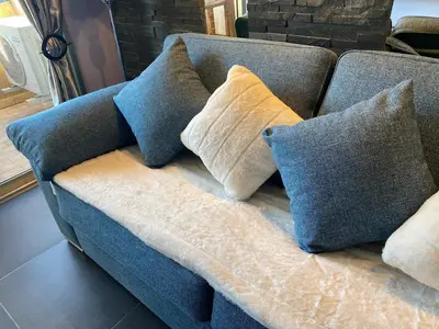 a blue couch with four pillows on it at Cannes Center in Cannes
