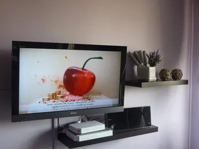 a television with a picture of a apple on the screen at Cannes Center in Cannes