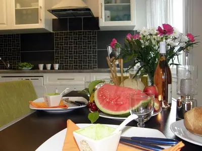 a table with a plate of watermelon and a bottle of wine at Cannes Plage in Cannes