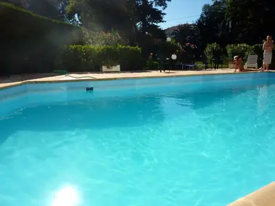 a large pool of blue water in a yard at Cannes Plage in Cannes