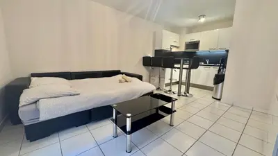 a small bedroom with a bed and a kitchen at Palazzio 2, by Welcome to Cannes in Cannes