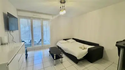 a bedroom with a bed with a chair and a window at Palazzio 2, by Welcome to Cannes in Cannes