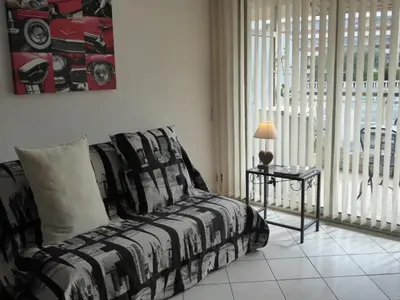 a bedroom with a bed and a table with a lamp at Mimosa in Cannes