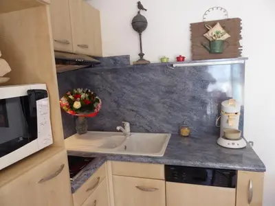 a kitchen counter with a sink and a microwave at Mimosa in Cannes