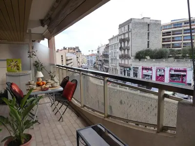 a balcony with a table and chairs on a balcony at Mimosa in Cannes
