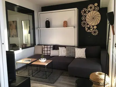a living room with a couch and a table at Bleu Regard in Cannes