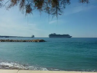 a large ship in the water with a beach at Bleu Regard in Cannes