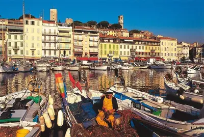 a man sitting on a boat in a harbor at Bleu Regard in Cannes