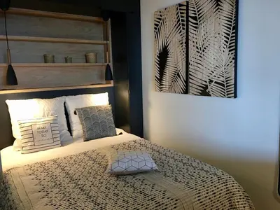 a bedroom with a bed with a picture on the wall at Bleu Regard in Cannes