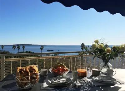 a table with food and a view of the ocean at Bleu Regard in Cannes