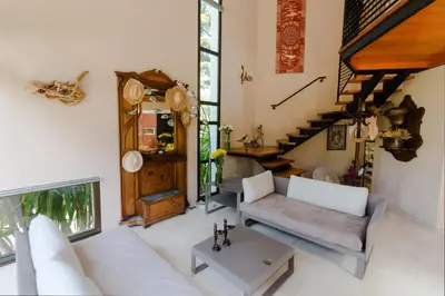 a living room with a white couch and a table at Villa Tsavorite - Cannes Californie in Cannes