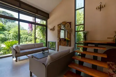 a living room with a couch and a table at Villa Tsavorite - Cannes Californie in Cannes