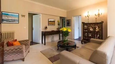 a living room with a couch and a table at Villa Tsavorite - Cannes Californie in Cannes