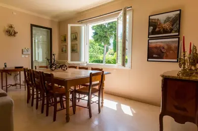 a dining room with a table and chairs and a window at Villa Tsavorite - Cannes Californie in Cannes