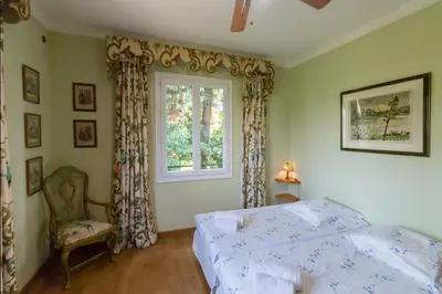 a bedroom with a bed and a window at Villa Tsavorite - Cannes Californie in Cannes