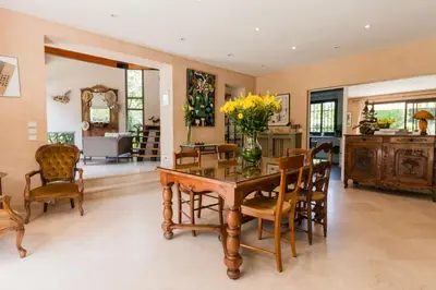 a dining room with a table with a vase of flowers on it at Villa Tsavorite - Cannes Californie in Cannes