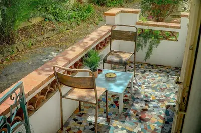 two chairs and a table on a mosaic floor at Le Alex - 800m des plages - extérieur - Verrière Côte d'Azur in Cannes